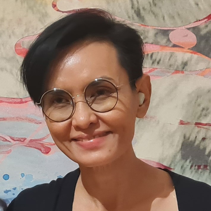 woman with short cropped hair and round glasses